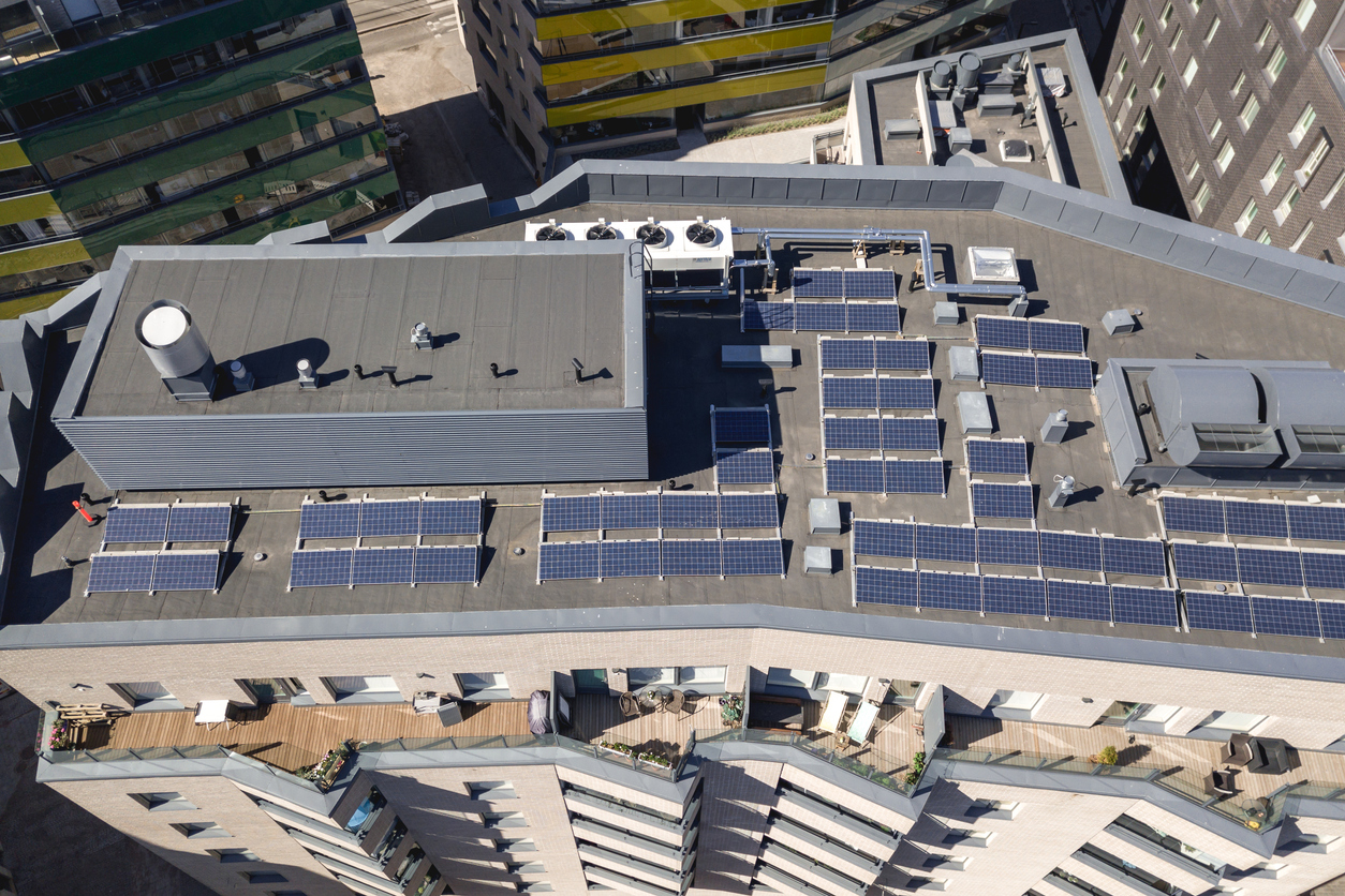 Solar panels on the roof of the multi-family houses, aerial view